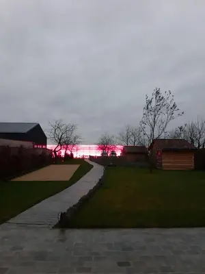 a walkway leading to a building with red lights at De Bonderbei in Wellen