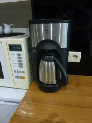 a coffee maker is sitting next to a microwave at Vakantie woning De Loft in Dilsen-Stokkem