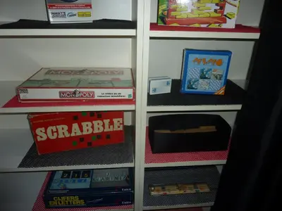 a book shelf filled with lots of games and toys at Vakantie woning De Loft in Dilsen-Stokkem