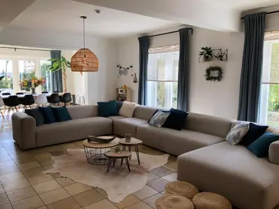 a living room with a couch and a table at Vakantiehuis Elisa in Alken