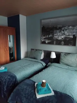 a bedroom with two beds with a towel on the bed at CASA Victoria in Kuringen