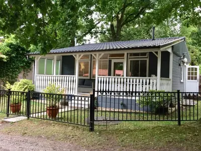 a small house with a fence in front of it at Chalet Belvedere in Lanaken in Lanaken