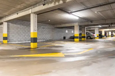 an empty parking garage with yellow and black columns at Esplanada Studios in Genk