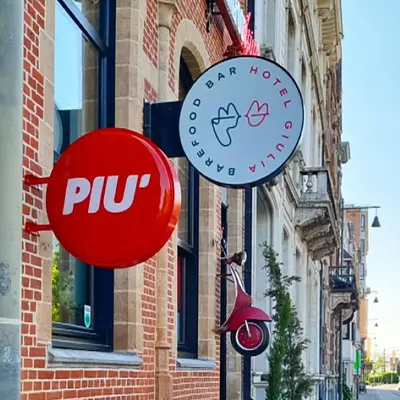 a group of signs on the side of a building at BareFoodGIULIA - Inspiration Hotel in Hasselt