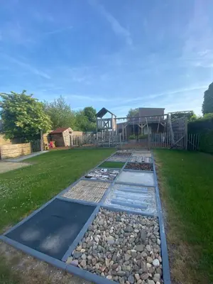 a garden with a playground in the background at ‘t Vaerthuys in Dilsen-Stokkem