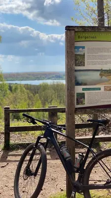 a bike is parked next to a sign at ‘t Vaerthuys in Dilsen-Stokkem
