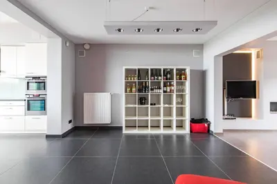a living room with a television and a kitchen at La Maison de Marie in Borgloon