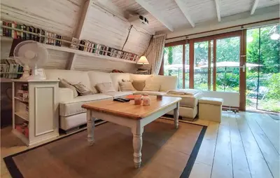 a living room with a couch and a table at Awesome Home In Rekem-Lanaken With Wifi in Bovenwezet