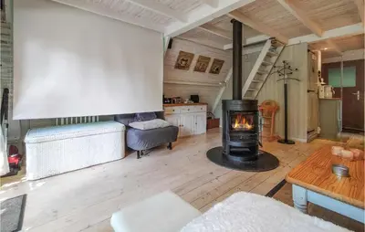 a living room with a wood burning stove in it at Awesome Home In Rekem-Lanaken With Wifi in Bovenwezet