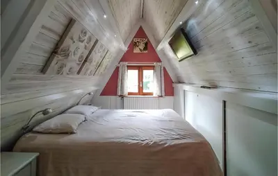 a small bedroom with a bed in a attic at Awesome Home In Rekem-Lanaken With Wifi in Bovenwezet