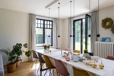 a dining room with a long table and chairs at De Sjieper in Lanaken