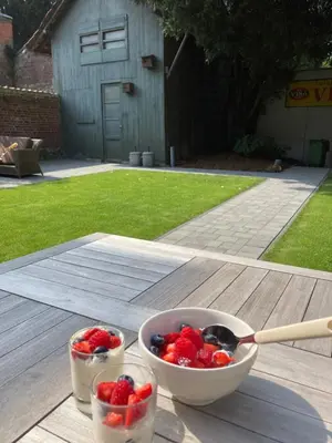 two bowls of strawberries and berries on a wooden table at B&B Gaudium XII in Tongeren