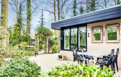 a house with a patio with a table and chairs at Beautiful Home In Rekem-Lanaken in Bovenwezet