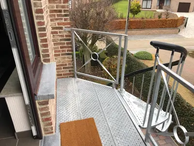 an open door with a metal railing on a porch at Gastenverblijf 't Princenhuis in Vechmaal