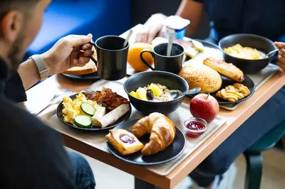 a table with a tray of breakfast food on it at B&B HOTEL Liège Rocourt in Liège