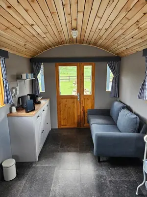 a living room with a couch and a table at B&B Hoeve De Brieser in Heers