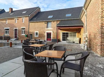 a group of tables and chairs on a patio at B&B Hoeve De Brieser in Heers