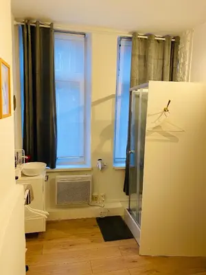 a bathroom with a refrigerator and a window at Roture 88 in Liège