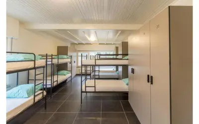 a room with several bunk beds in a dorm room at Vakantiewoning Vennekens in Peer