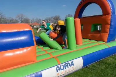 two people playing in an inflatable playground at Kamphuis Heideven in Peer