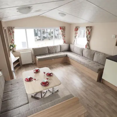a living room with a couch and a table at Vakantiepark Wilhelm Tell Superieur Chalet in Oudsbergen