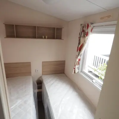 a small room with a bed and a window at Vakantiepark Wilhelm Tell Superieur Chalet in Oudsbergen