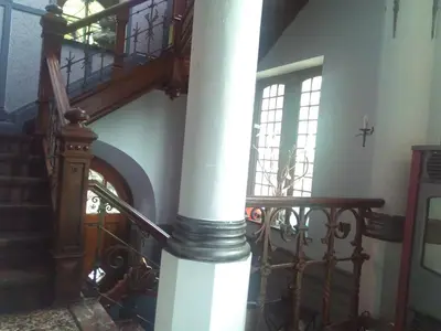 a spiral staircase with a white column in a building at B&B Chatelet Cremers in Verviers
