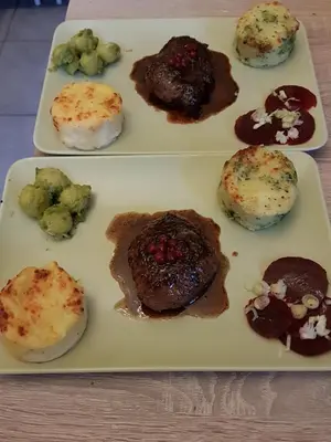 two white plates of food on a table at B&B Chatelet Cremers in Verviers