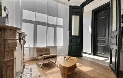 a room with a table and a chair and a door at Tokyo's Place in Liège
