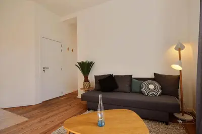 a living room with a couch and a table at Tokyo's Place in Liège