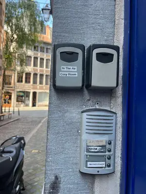 a pay box on the side of a building at In The Air cosy room (Cœur Historique de Liège) in Liège