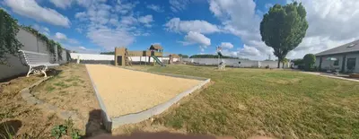 a playground in a yard with a park with a building at Spelver95 in Bilzen