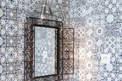 a mirror on a wall in a bathroom at Ryad Mogador Liège in Liège