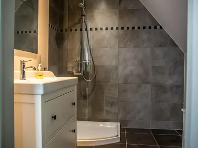 a bathroom with a shower and a sink at Peaceful Peer Holiday Home in Peer