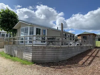 a house with a large deck on the side of it at Chalet 11 - Bergzicht Teuven in Teuven