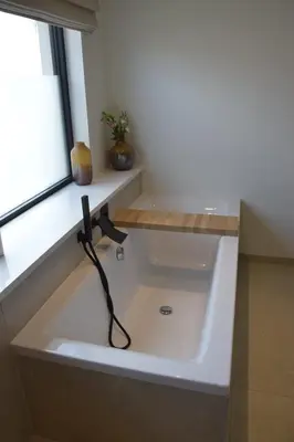 a bath tub in a bathroom with a window at B&B Villa Mimosa in Pelt