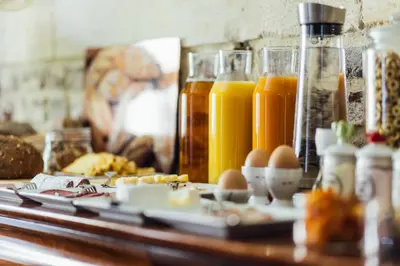 a table with eggs and bottles of orange juice at De Zwarte Stok in Riemst
