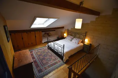 an attic bedroom with a bed and a skylight at De Zwarte Stok in Riemst