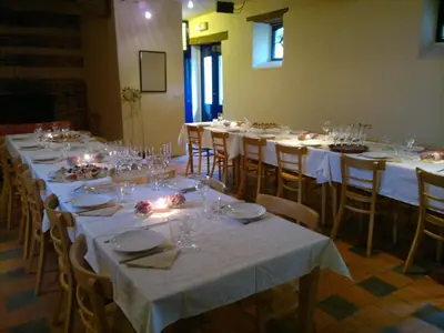 a group of tables with white tablecloths and glasses at De Zwarte Stok in Riemst
