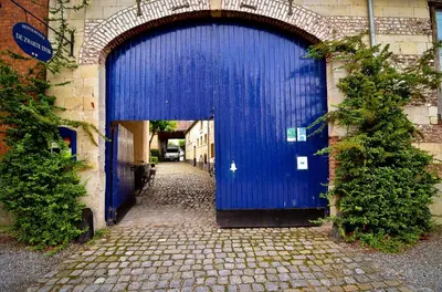 a blue door on the side of a building at De Zwarte Stok in Riemst
