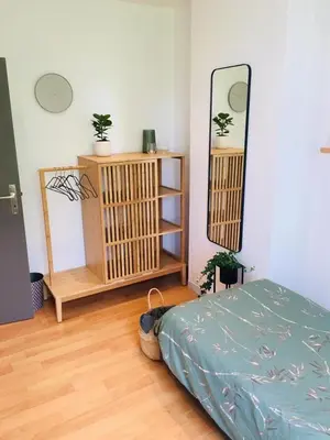 a bedroom with a bed and a mirror on the wall at Les charmilles in Chaudfontaine