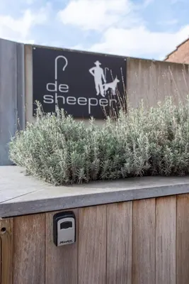 a sign on a fence with plants on it at NEW - De sheeper - 10Personen - 5slaapkamers - Sauna - Jacuzzi in Riemst