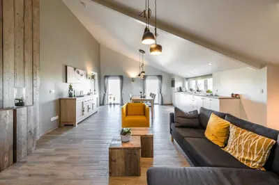a living room with a couch and a table at Bed en Vrijheid in Peer