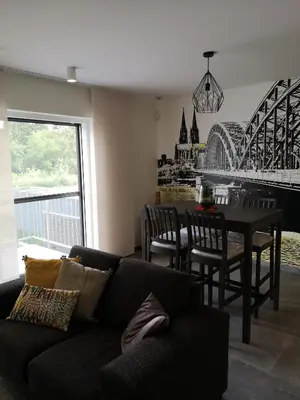 a living room with a black couch and a table at Vakantiewoning Atuatuca in Tongeren