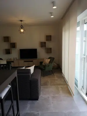 a living room with a couch and a television at Vakantiewoning Atuatuca in Tongeren