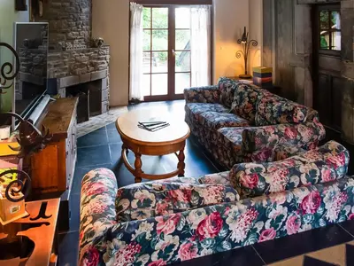 a living room with a couch and a table at Holiday home with sauna and swimming pool in Verviers