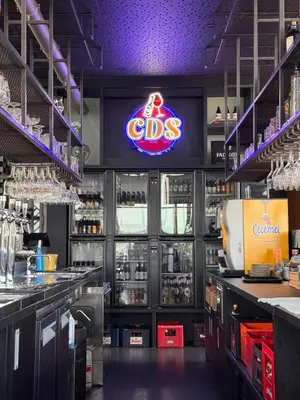a bar with a cds sign on the wall at Hof van Stayen in Sint-Truiden