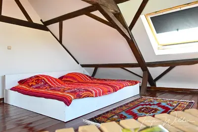 a bed in the corner of a room at Landhaus Lontzen in Lontzen