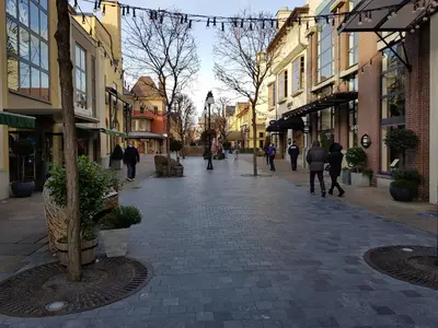 a city street with people walking down the street at De achtertuin in Maasmechelen