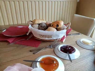 a basket of bread sitting on top of a table at Logies Mario in Tongeren